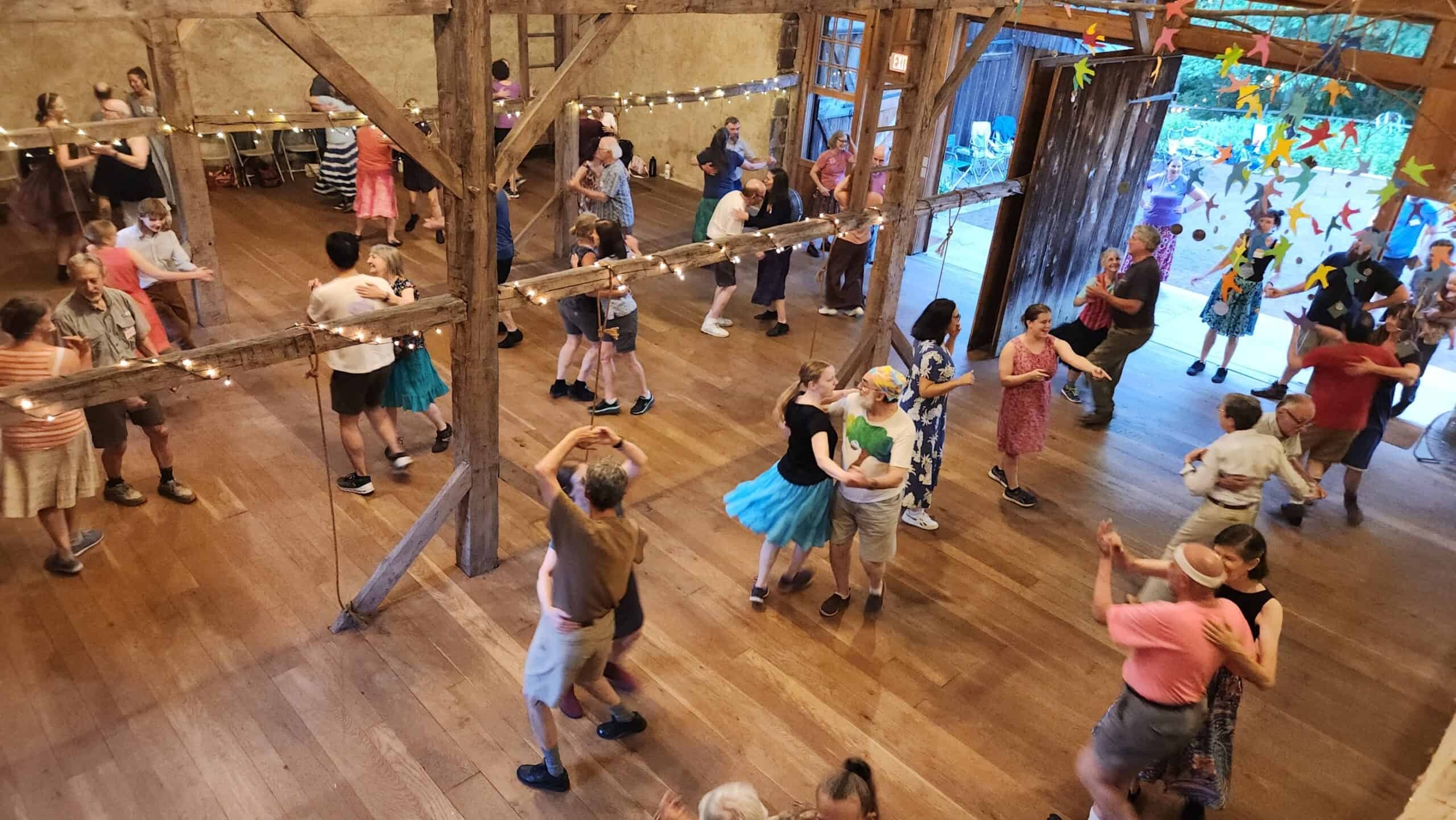 A view looking down on people contra dancing in a barn