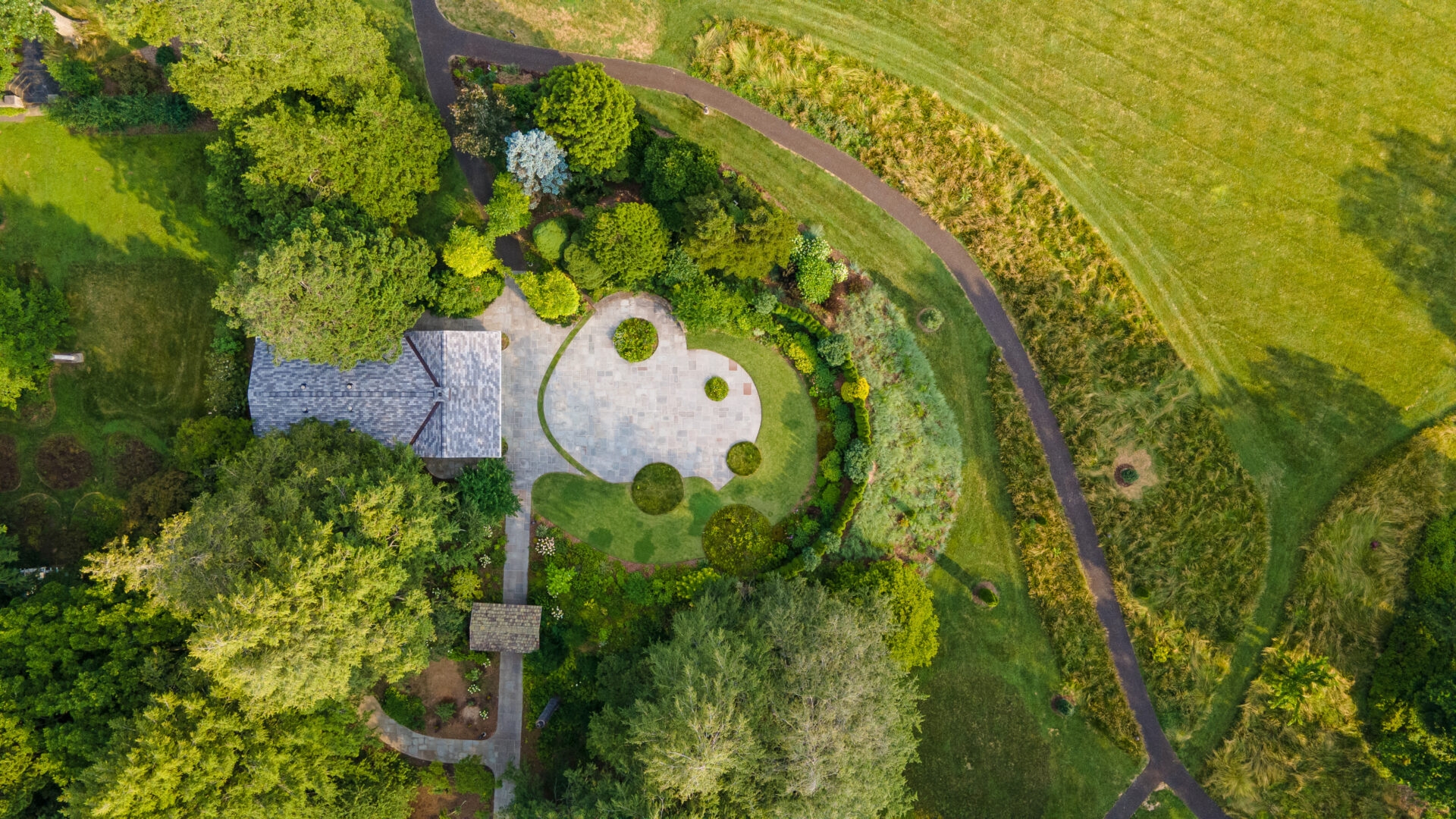 Photo by Benjamin Szmidt
 - A drone photo of the landscaped area around the Pool House at Stoneleigh.
