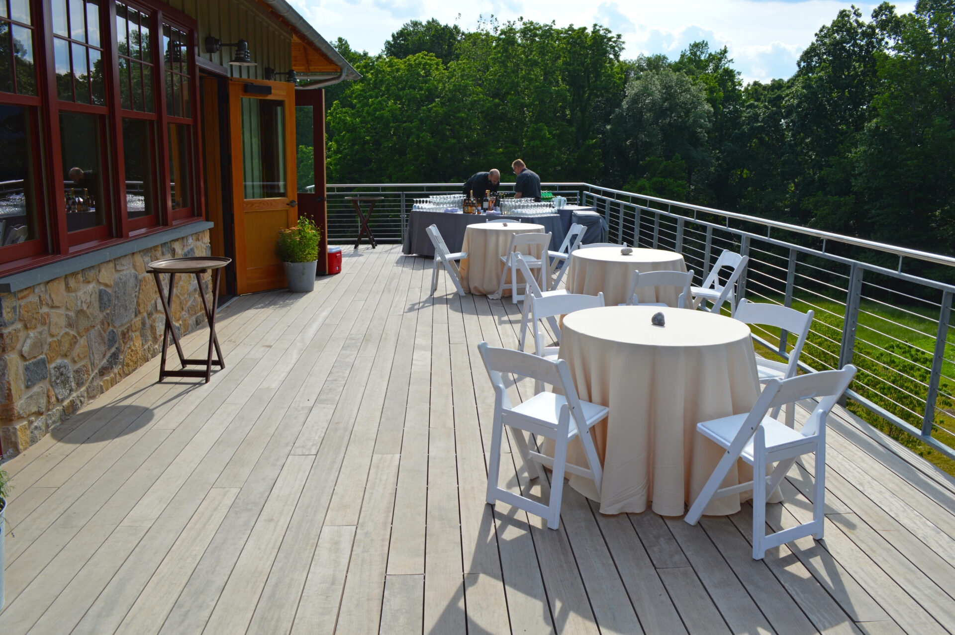 Photographer unknown
 - Folding chairs and circular tables set up for an event on the desk of the Lenfest Center at ChesLen Preserve.
