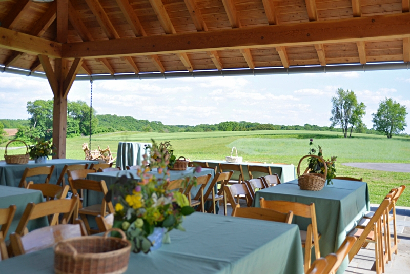 Photo by Jim Moffett
 - Tables and chairs set up for an event under the pavilion at the Lenfest Center at ChesLen Preserve.
