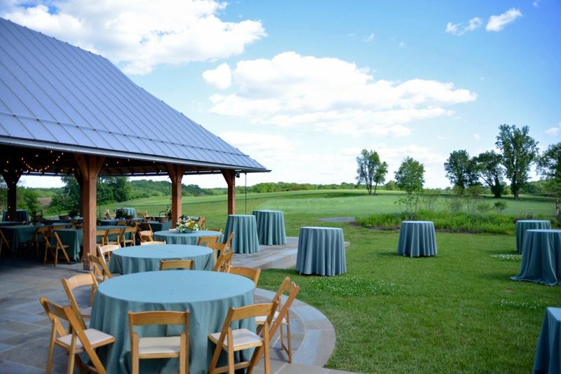 Photo by Jim Moffett
 - Tables and chairs set up under and near the pavilion at the Lenfest Center at ChesLen Preserve.
