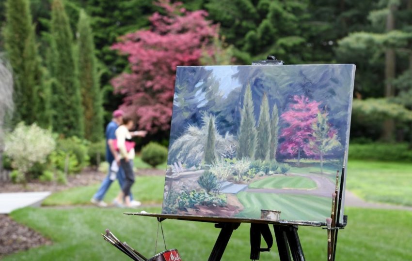 A painting in process outdoors in a garden.