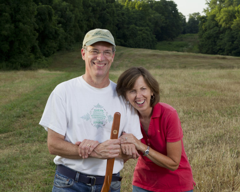 Portrait of smiling man and woman outdoors.