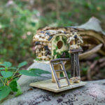 A fairy house made from natural materials outside.