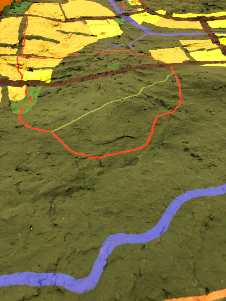 A map of a natural setting with a red section outlined on it.