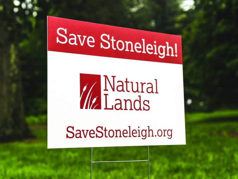 A sign in the grass reads "Save Stoneleigh" and "Natural Lands."