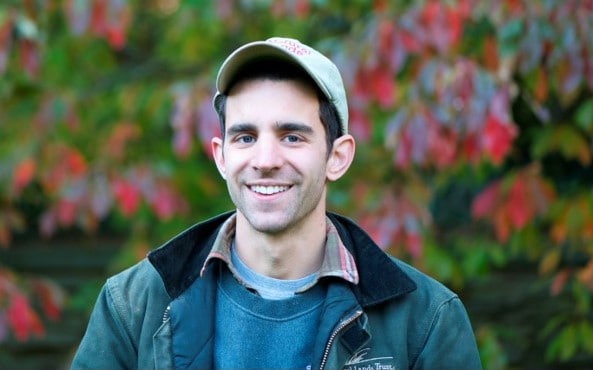Photo of a man outdoors smiling at camera