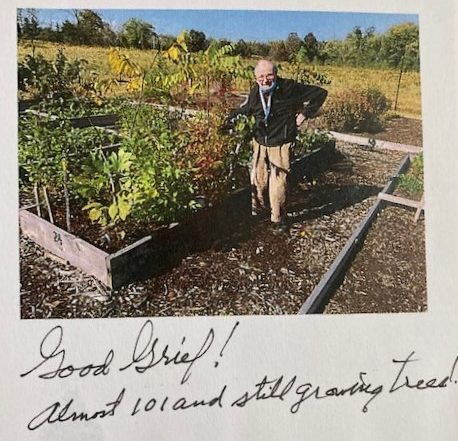 Photo of Paul Felton at 101 standing next to his garden.