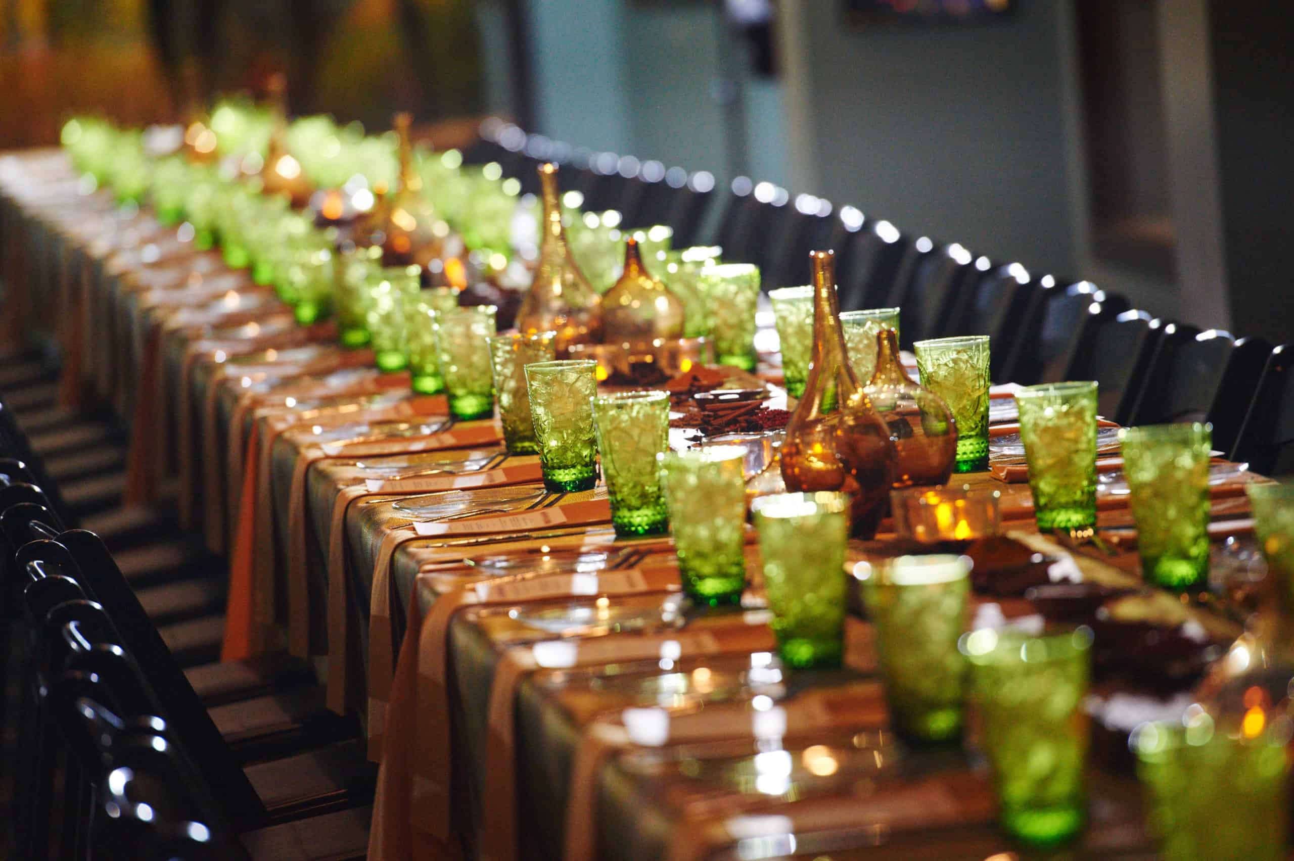 A table laden with green and amber glassware