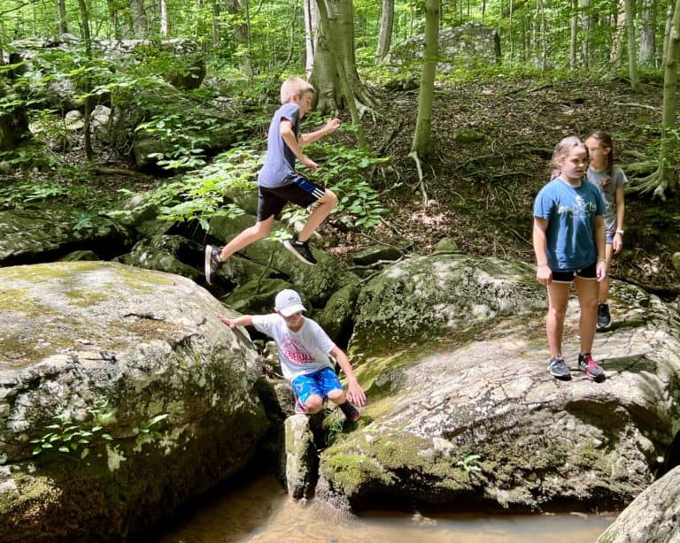Kids playing on the boulders at Mine Run at Crow's Nest Preserve