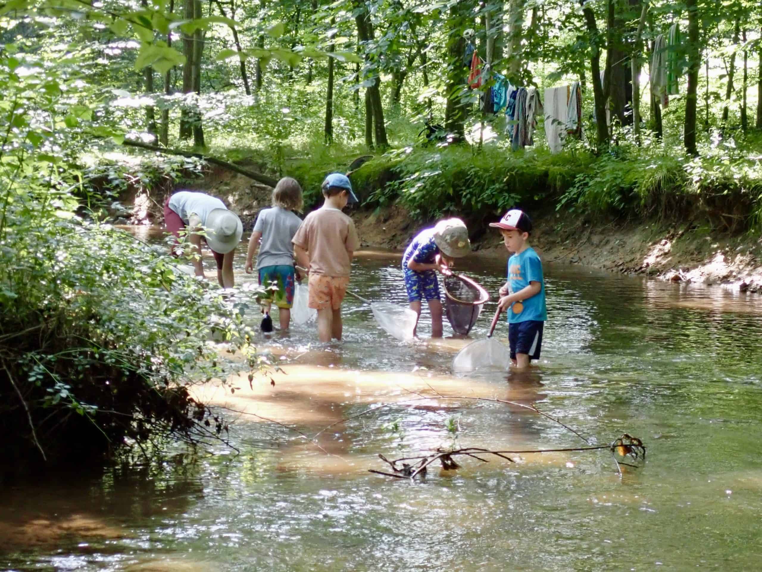 Kids playing in Pine Creek at Crow's Nest Camp
