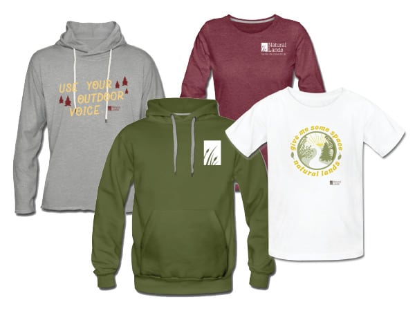 A collection of shirts, sweatshirts, and travel mugs with the Natural Lands logo.