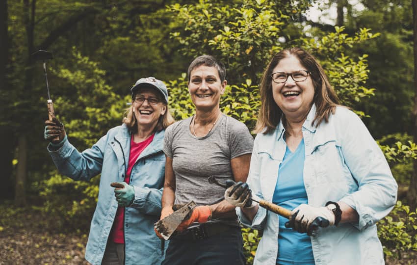 A smiling group of three female volunteers