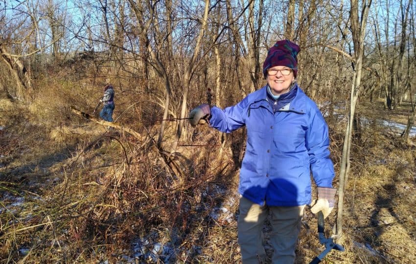 A volunteer bundled up and smiling at the camera on a wintery day, MLK Day 2020.