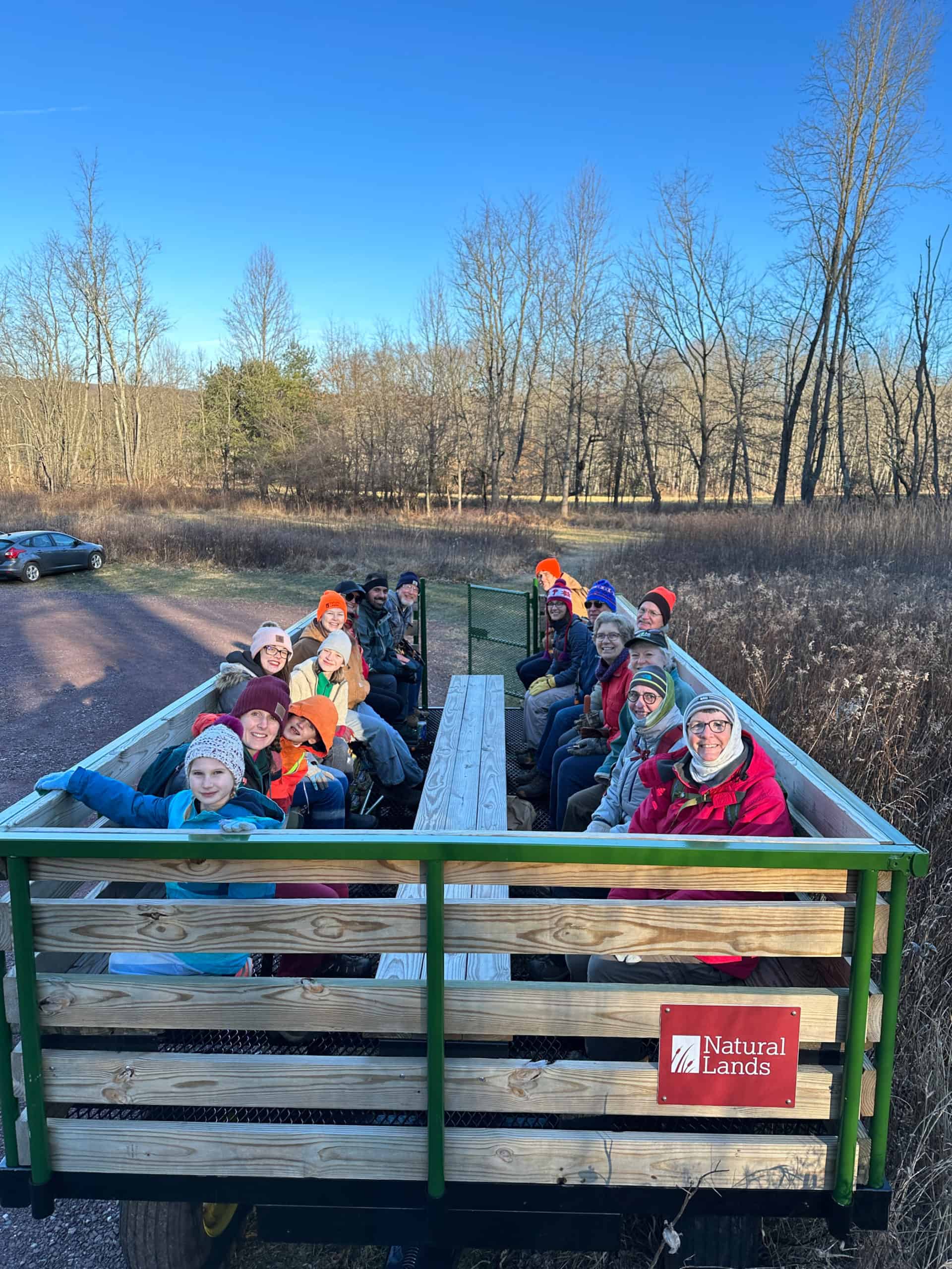 Volunteers bundled up against the cold on a hayride to a project area at Crow's Nest Preserve