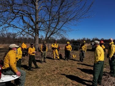 alt text: Preserve managers gather in preparation for a prescribed burn in mid-March