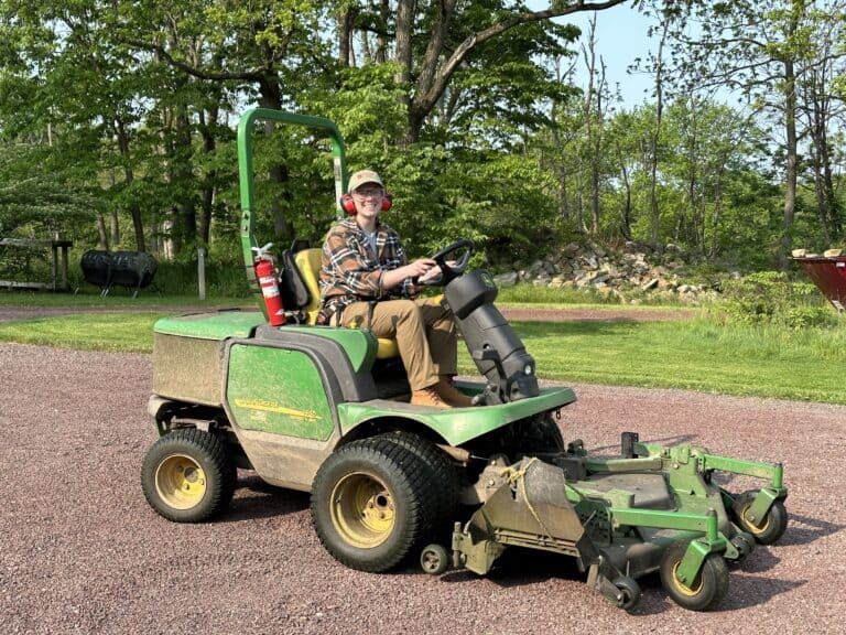 Person driving a riding mower