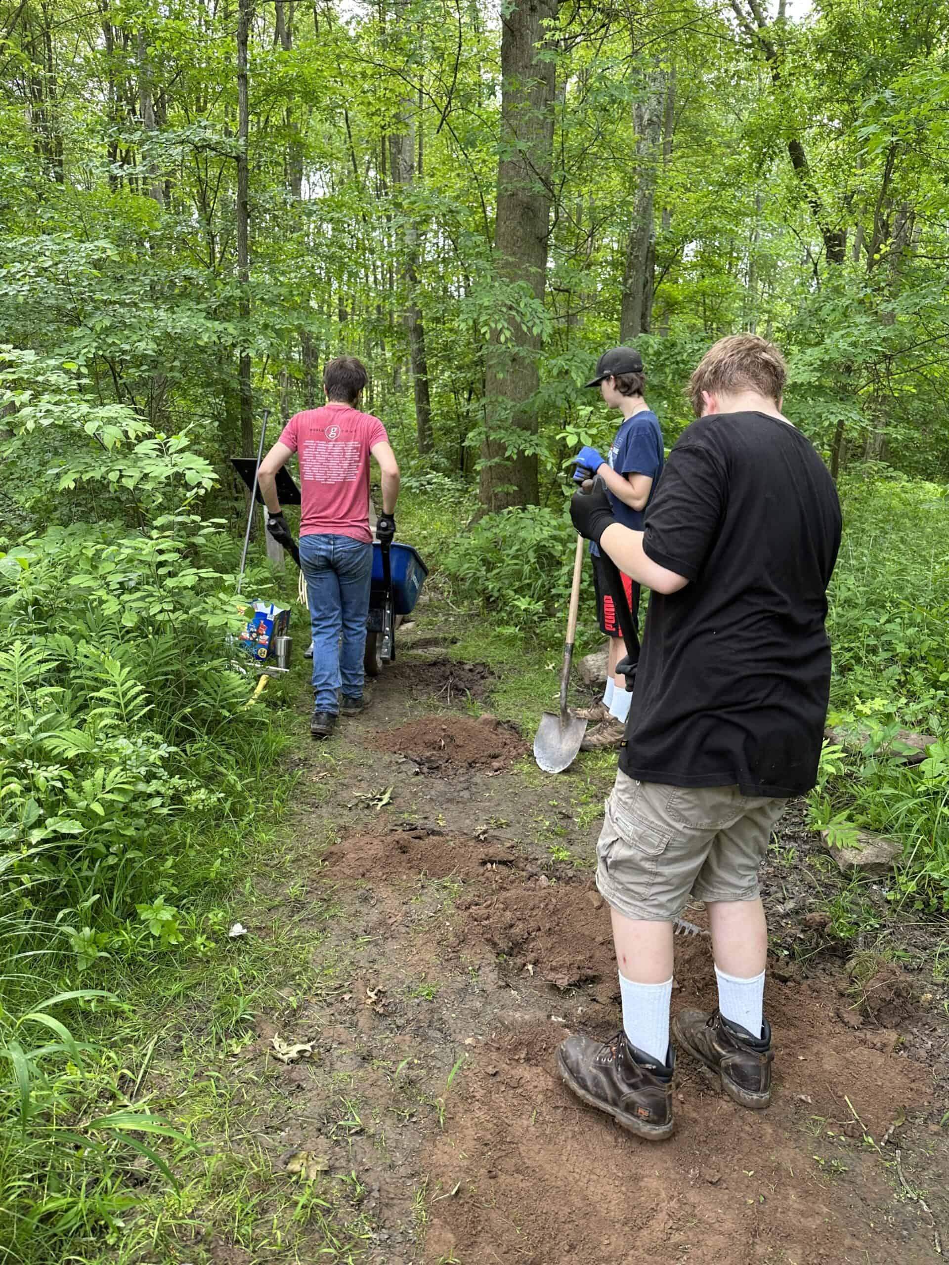 Scouts preparing trail for gravel improvements