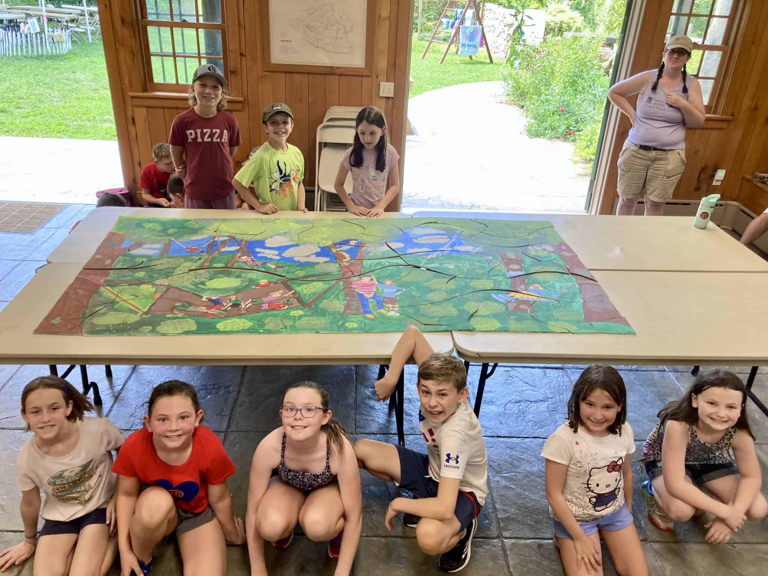 Kids posing with a giant puzzle they completed