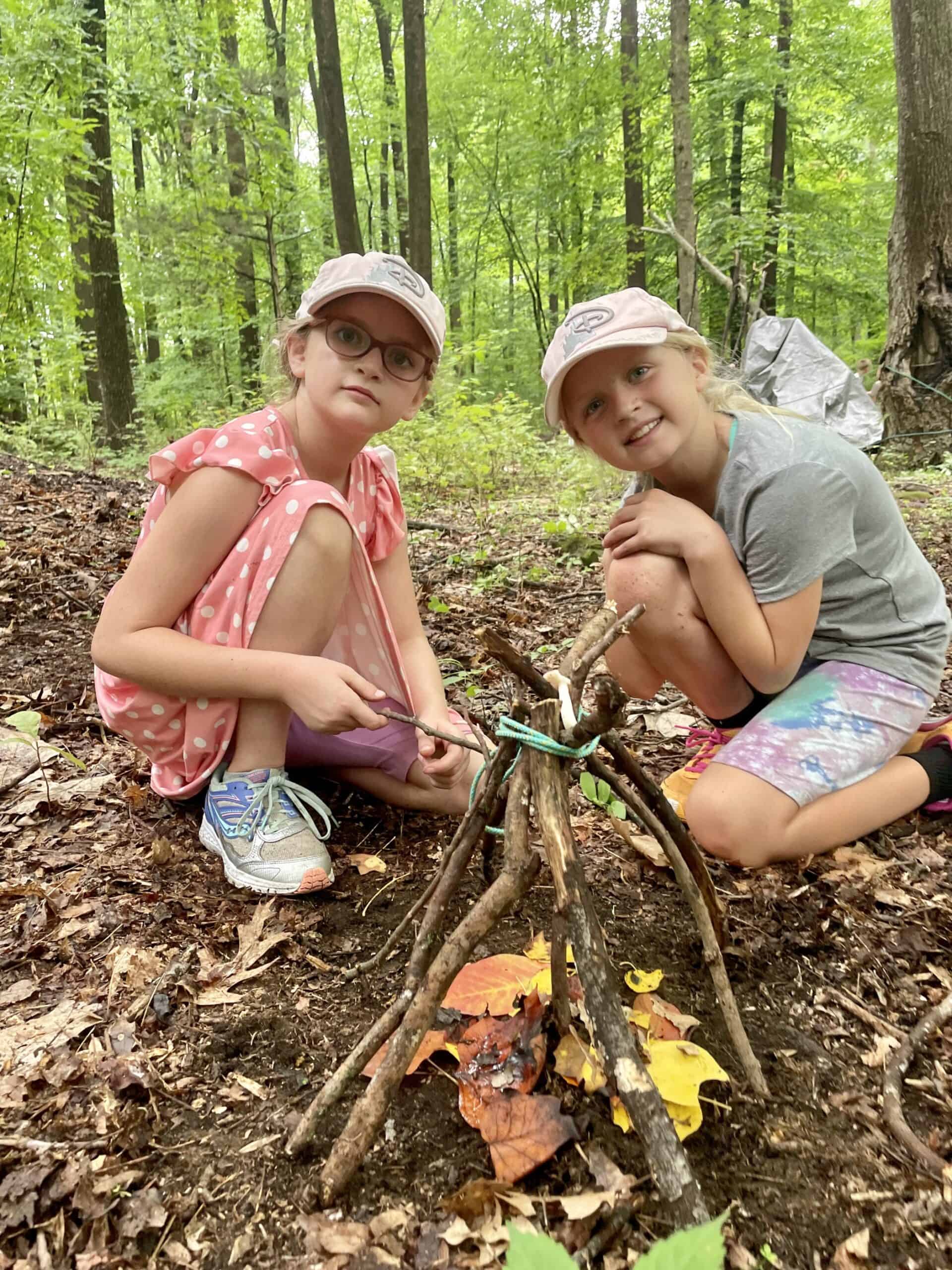 Kids playing in the woods at Crow's Nest Camp