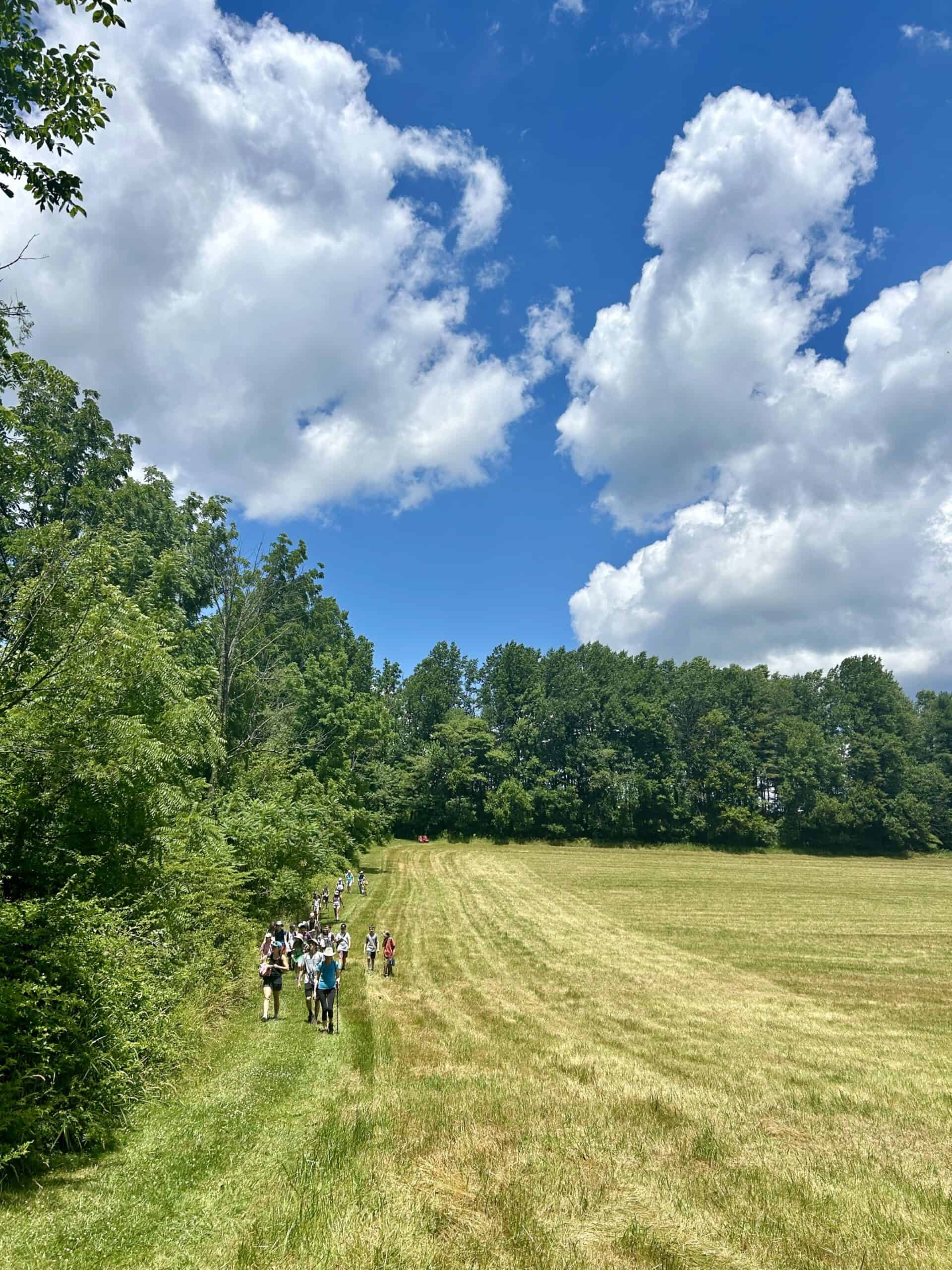 Camp kids hiking along a farm field edge