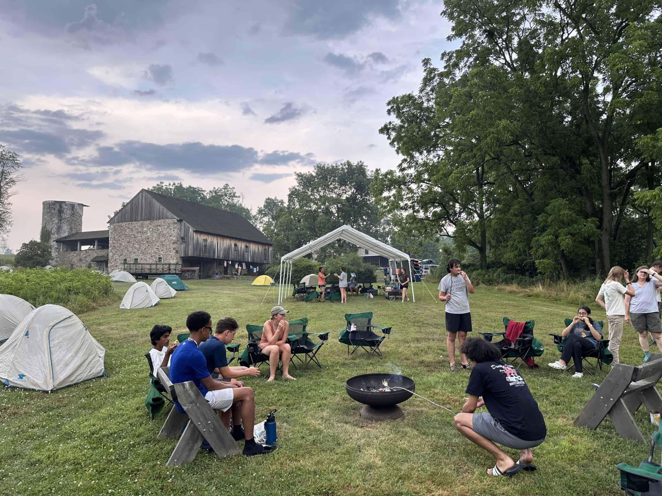 Campers relaxing around a campfire.