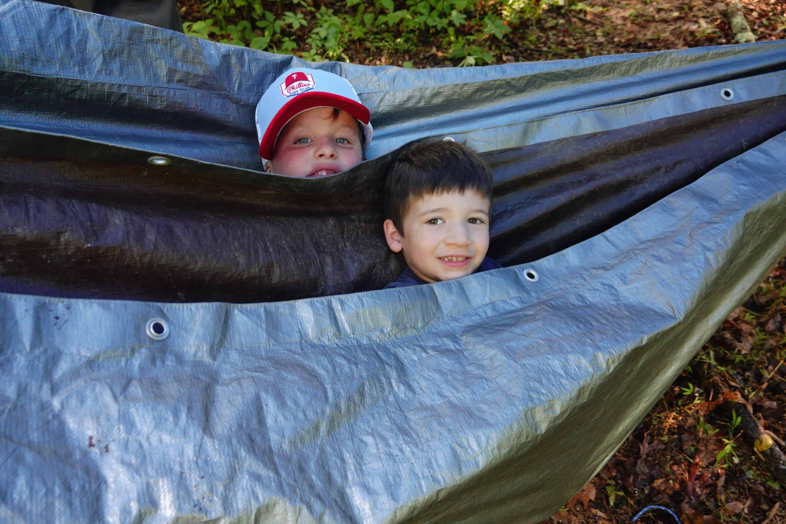 Kids at summer camp playing in a hammock