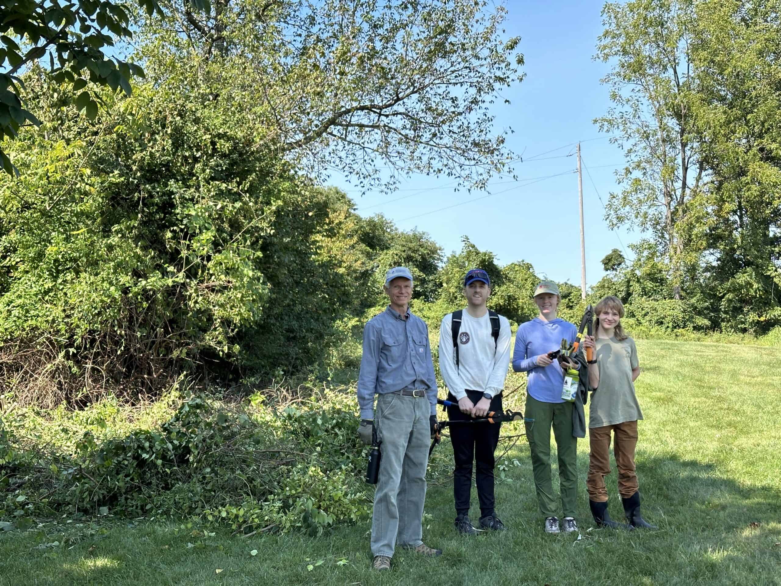 A group of volunteers posing with tools