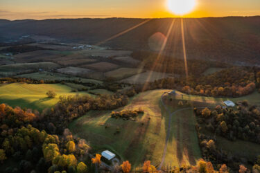 Sunset over the rolling green fields and woodlands of Ridge Farm